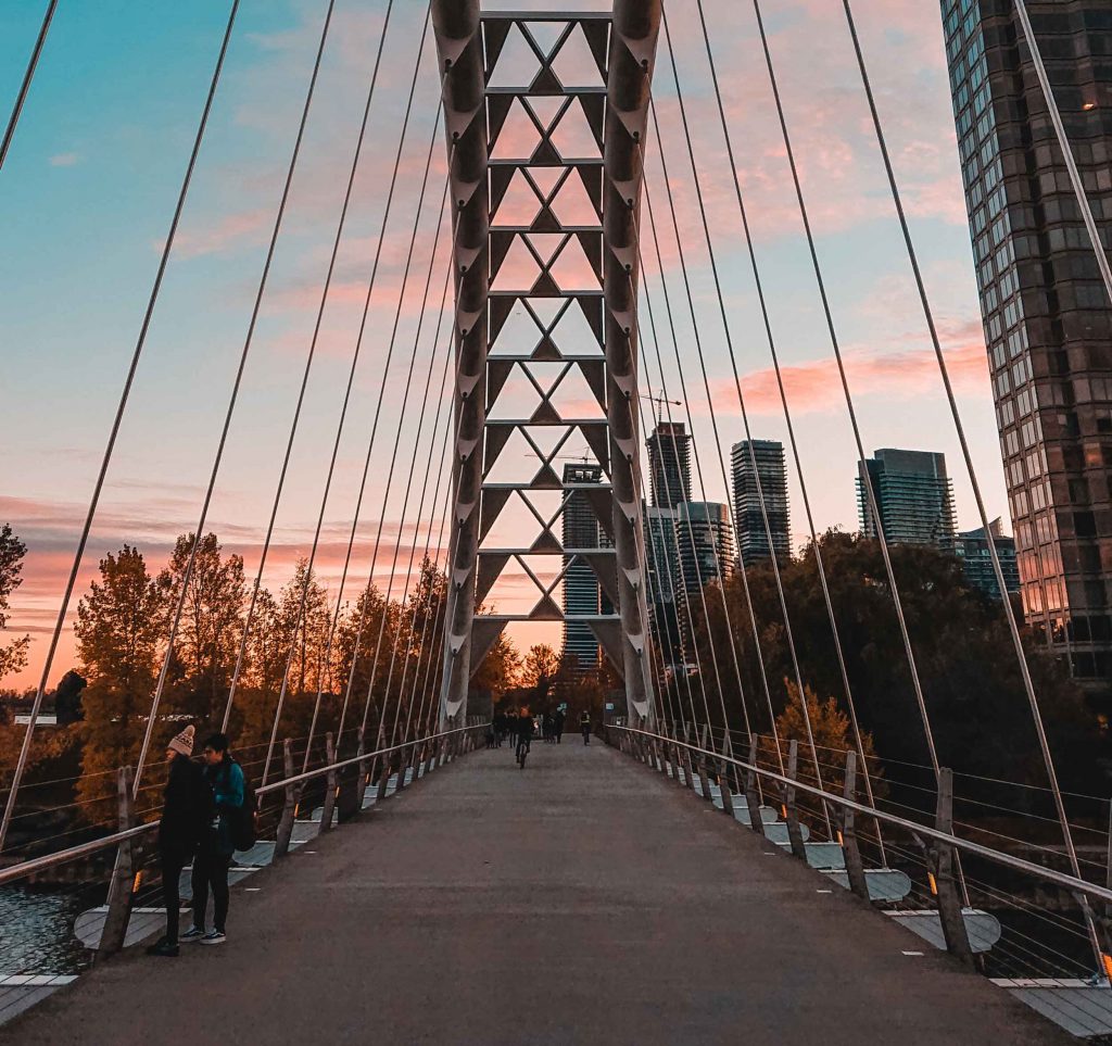 People on a bridge at sunset