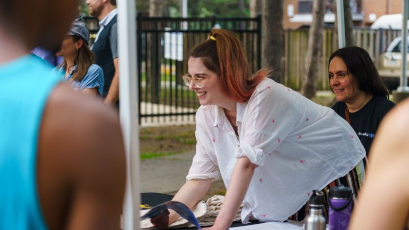 Retrofit Services Manager, Kaitlin Carroll discusses an upcoming heat pump installation with Toronto Community Housing residents. Photo by Nhan Ng Productions