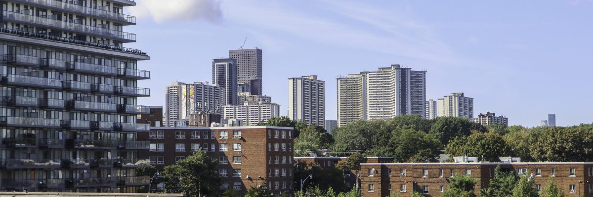 A view of Toronto. Trees are mixed in with high rise residential buildings and low rise apartments