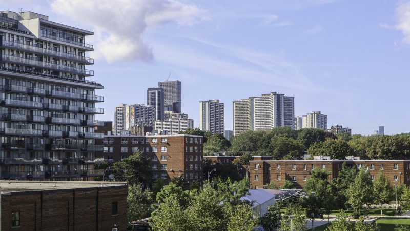 A view of Toronto. Trees are mixed in with high rise residential buildings and low rise apartments